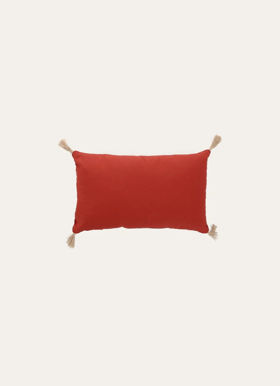 COUSSIN EN COTON UNI AVEC POMPONS EN JUTE ROUILLE